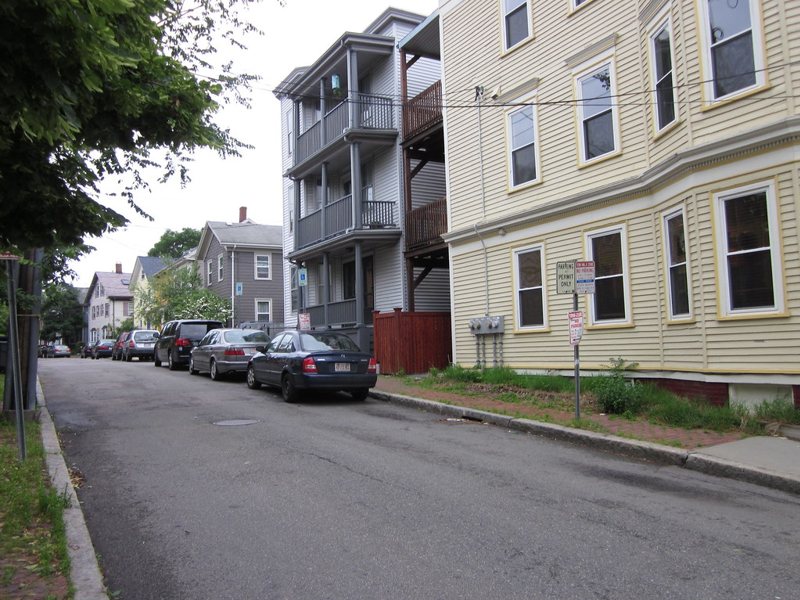 Triple-decker homes on a Greater Boston street